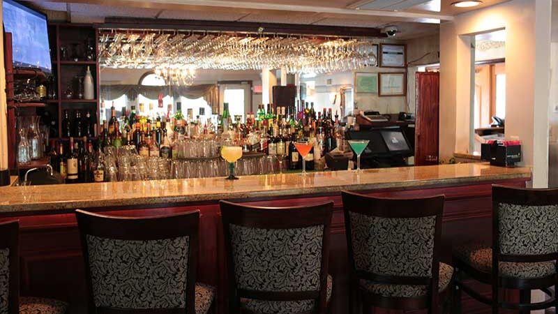 Bar area with three cocktails on bar top