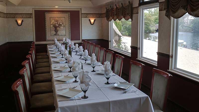 Banquet room with long table set for eighteen guests