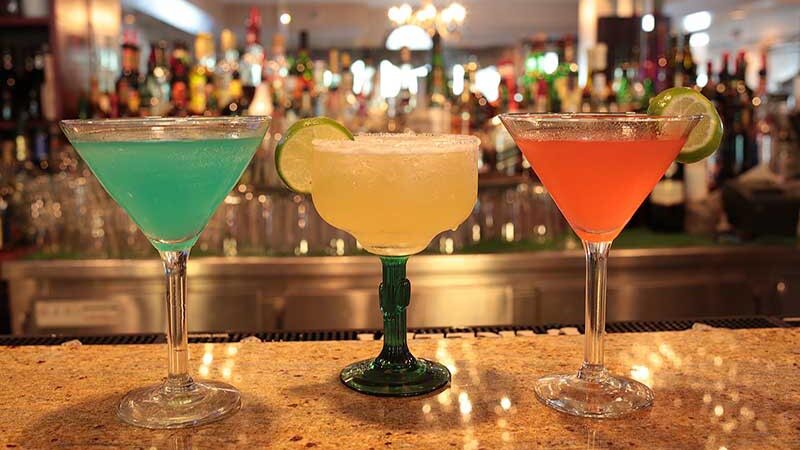 Three cocktails on bar top